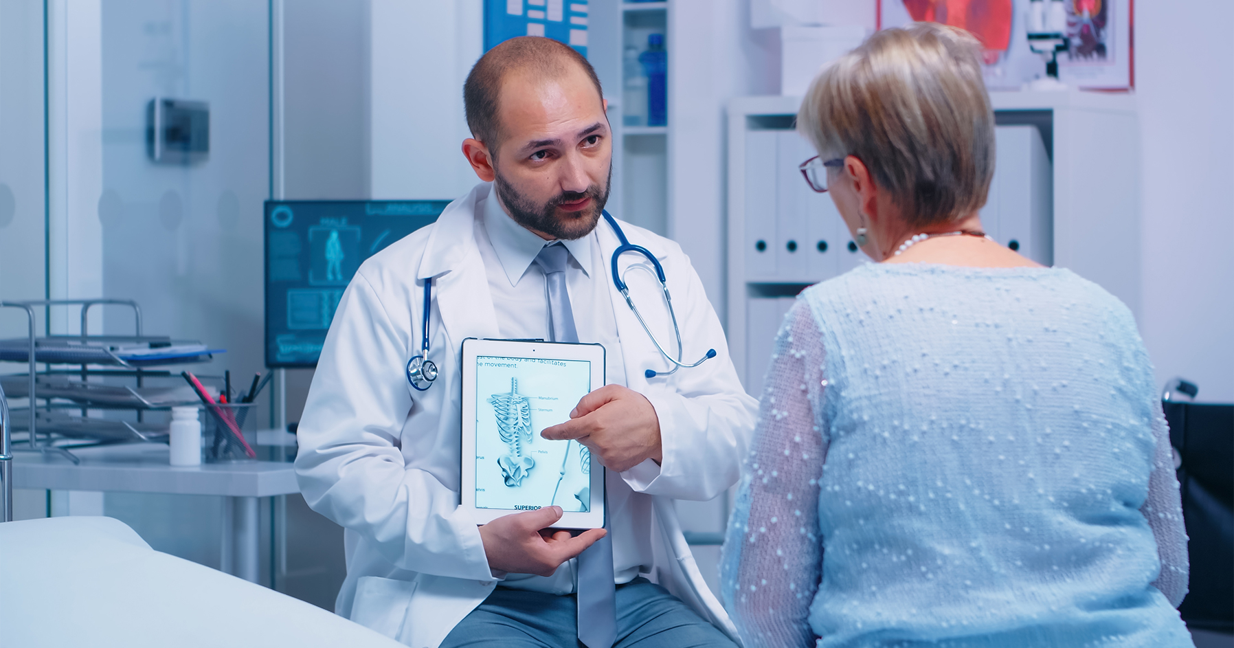 Image of physician discussing osteoporosis treatment options with patient.  