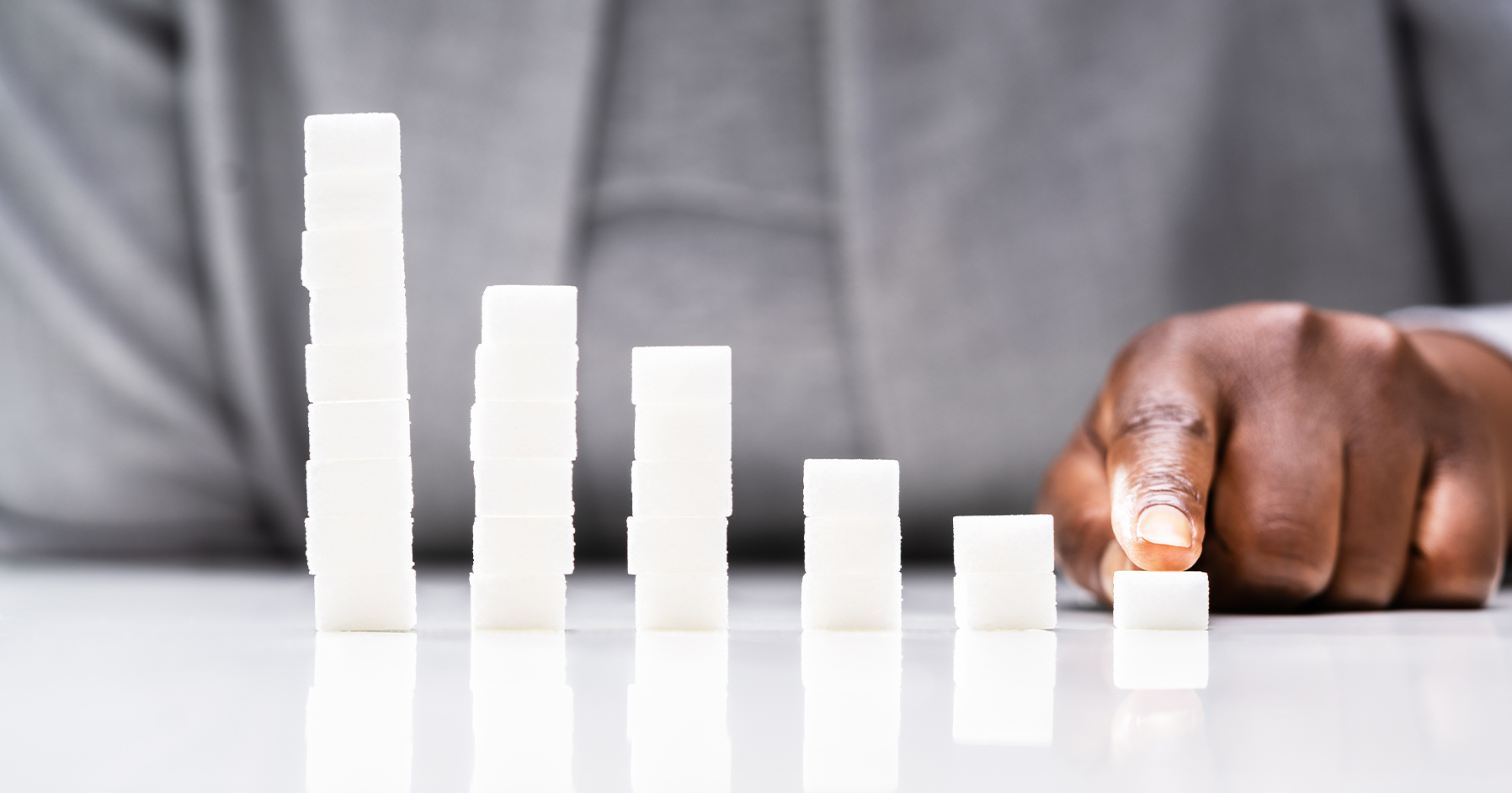 Image of adult looking at sugar cubes.