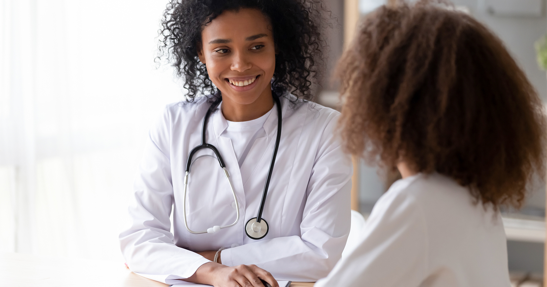 Image of a doctor discussing puberty with a patient. 